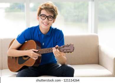 Portrait of a teen guitar player smiling at the camera - Powered by Shutterstock