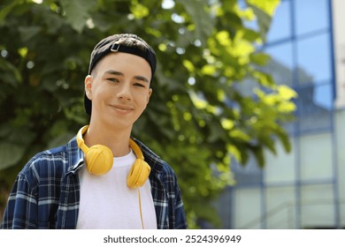 Portrait of teenage boy with headphones outdoors. Space for text - Powered by Shutterstock