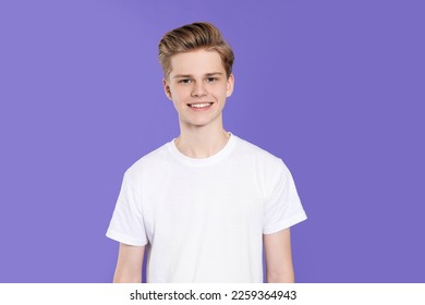 Portrait of teenage boy on purple background - Powered by Shutterstock