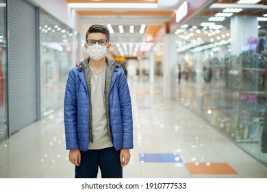 Portrait Of A Teenage Boy Wearing A Protective Mask In An Empty Shopping Mall During A Pandemic