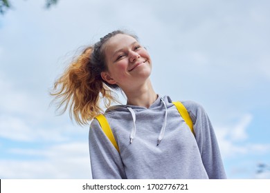 Portrait Of Teenage Girl 15 Years Old, Smiling Pretty Girl In Gray Sweatshirt, Background Sky