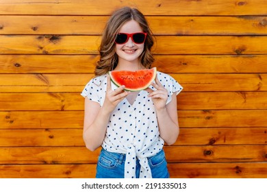 Portrait Of Teenage Girl Eating Watermellon On Wooden Background. Young Female Enjoy Life On Summer. Outdoor Travel Vacation Healthy Lifestyle Vegan Food Picnic Children With Snacks.