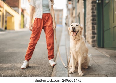 A Portrait of teenage girl having fun outside with golden retriever - Powered by Shutterstock