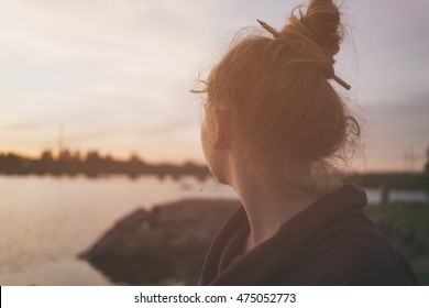portrait of teenage girl on embankment in sunset, toned photo - Shutterstock ID 475052773