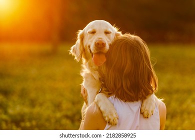 A Portrait of teenage girl petting golden retriever outside in sunset - Powered by Shutterstock