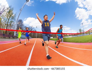 Portrait Of Teenage Sprinter Crossing Finish Line