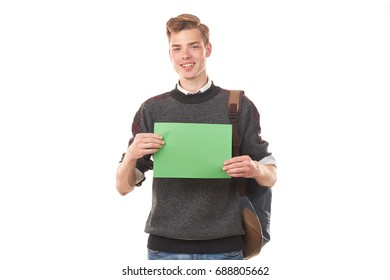 Portrait Of Teenage Student Holding Blank Paper Against White Background