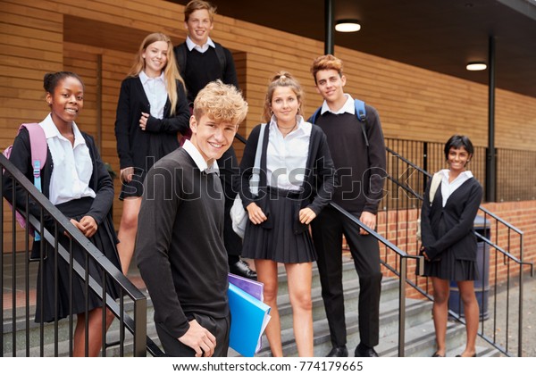 Portrait Of Teenage Students In Uniform Outside\
School Building