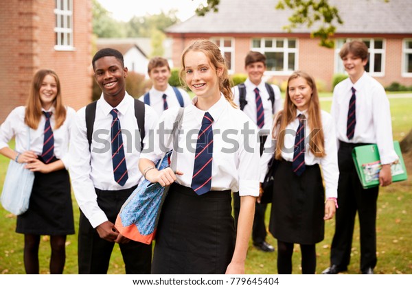 Portrait Of Teenage Students In Uniform Outside\
School Buildings