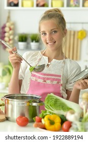 Portrait Of A Teenager Girl Coocking Soup On Kitchen