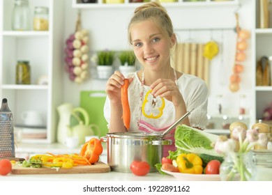 Portrait Of A Teenager Girl Coocking Soup On Kitchen