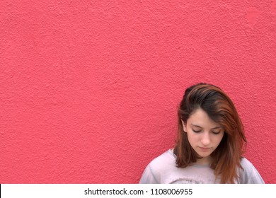 Portrait Of A Teenager Leaning Against A Wall Looking Down