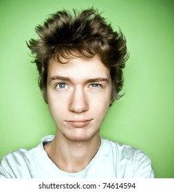 Portrait Of A Teenager Looking Up, On A Green Background.