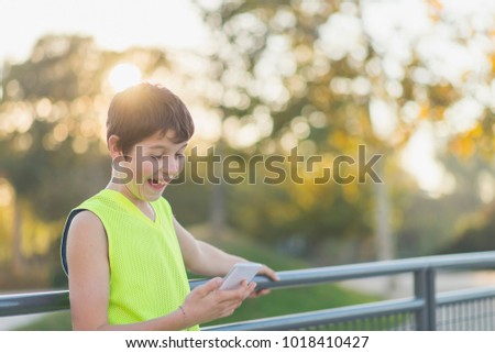 Similar – Teenager lächelnd, der sein Smartphone auf einem Basketballplatz aussieht.