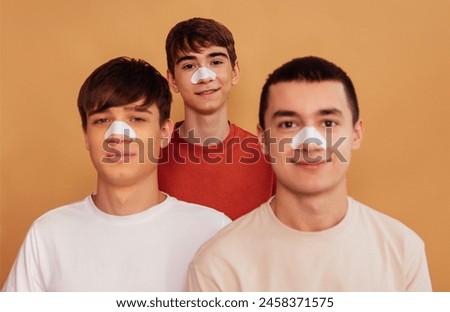 Similar – Image, Stock Photo Three boys take a run for the jump into the sea