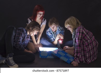Portrait of  teenagers looking in a magic lighting box