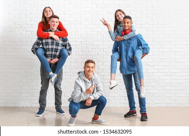 Portrait of teenagers near white brick wall