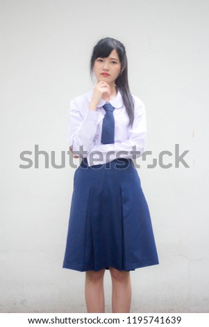 Portrait of thai high school student uniform beautiful girl Think