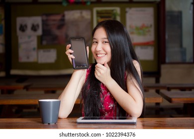 Portrait Of Thai Teen Beautiful Girl In Chinese Dress Using Smart Phone