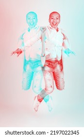 Portrait Of Thai Woman With Bright Clothes, Torn Jeans And Shaved Head Jumping In Air. RGB Color Split Effect Applied. Red And Blue Color Separation. Abstract And Futuristic Looking Style