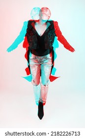 Portrait Of Thai Woman With Dark Clothes, Torn Jeans And Shaved Head Jumping In Air. RGB Color Split Effect Applied. Red And Blue Color Separation. Abstract And Futuristic Looking Style