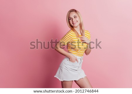 Portrait of thankful dreamy lady hands chest look side on pink background