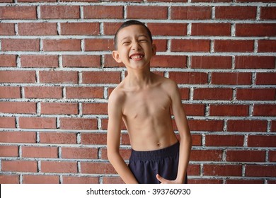 Portrait Thin And Young Boy Who Shirtless Showing His Muscle 