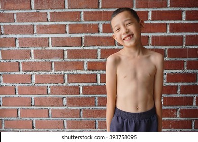 Portrait Thin And Young Malaysian Boy Posing Shirtless 