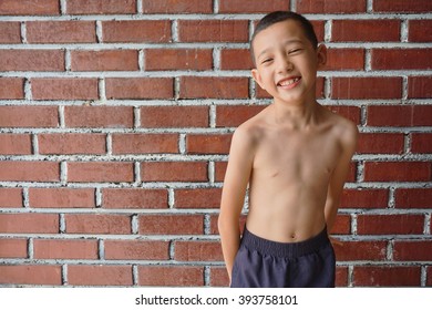 Portrait Thin And Young Malaysian Boy Posing Shirtless 