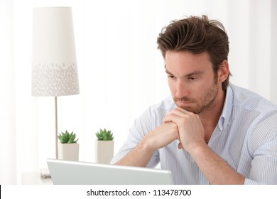 Portrait Of Thinking Man Using Laptop Computer At Home, Copyspace.