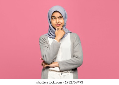 Portrait of thinking young Asian woman looking up and touch chin - Powered by Shutterstock