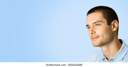 Portrait Of Thinking Young Handsome Man In Smart Casual Clothing Looking Forward Isolated Over Bright Blue Color Background With Mock Up Copy Space For Some Slogan Or Text. Male Person Model At Studio