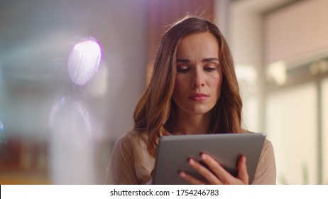 Portrait Of Thoughtful Businesswoman Using Tablet Computer At Remote Place. Close Up Of Serious Lady Browsing Internet On Tablet At Home In Slow Motion. Business Woman Working On Pad On Kitchen