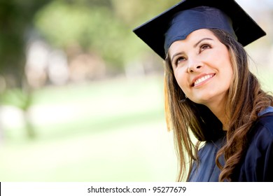 Portrait Of A Thoughtful Graduation Student Looking Up Outdoors