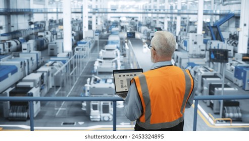Portrait of a Thoughtful Middle Aged Engineer Monitoring and Analyzing Conditions at a Modern Electronics Factory with Automated Robots Working with the Help of Artificial Intelligence Software - Powered by Shutterstock