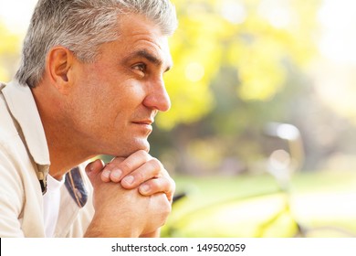 Portrait Of Thoughtful Middle Aged Man Outdoors