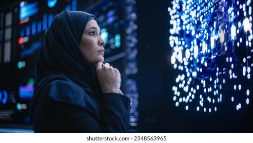 Portrait of a Thoughtful Middle Eastern Software Developer Working in Technological Corporate Office. Young Woman Testing Artificial Intelligence Algorithms for an Innovative Internet Project