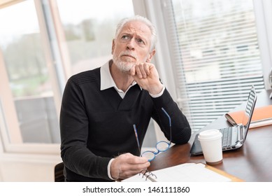 Portrait of thoughtful senior businessman at office