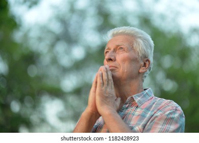 portrait of thoughtful senior man in park - Powered by Shutterstock