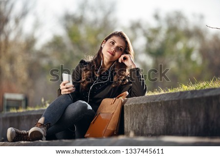 Similar – Image, Stock Photo Blonde woman looking at her smartphone outdoors