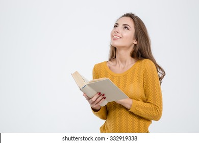 Portrait Of A Thoughtful Woman Holding Book And Looking Up At Copyspace Isolated On A White Background