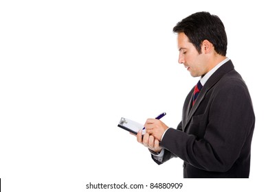 Portrait Of Thoughtful Young Business Man Taking Notes Against White Background