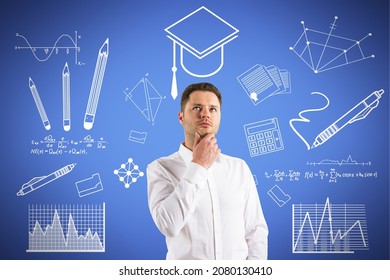 Portrait of thoughtful young european business man with creative knowledge and graduation sketch on blue wall background. Education and academic concept - Powered by Shutterstock