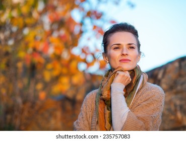 Portrait of thoughtful young woman standing in autumn outdoors in evening - Powered by Shutterstock