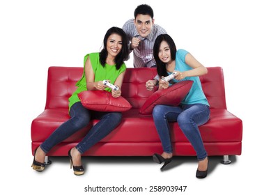 Portrait Of Three Asian People Having Fun By Playing Video Games Together, Isolated Over White