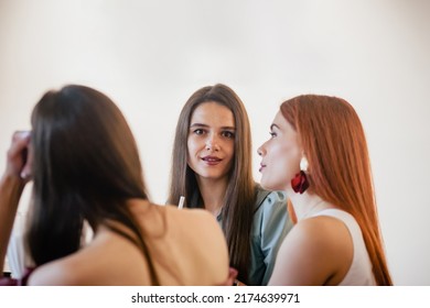 Portrait Of Three Attractive Women Triplets Chatting In Cafe