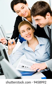 Portrait Of Three Business People Working Together In The Classroom