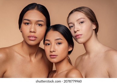 Portrait Of Three Caucasian, Korean And African American Woman With Face Skin Beauty And Purity Looking At Camera. Esthetic Studio Shot Of Young Female Of Diverse Nationality Advertising Cosmetics