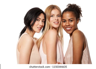 Portrait of three cheerful multinational young female with attractive appearance and different flawless skintone. Diverse friends concept. Isolated on white background