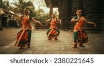 Portrait of Three Expressive Young Indian Dancers Performing Folk Dance Choreography in an Ancient Temple. Women in Traditional Clothes Dancing Bharatanatyam in Colourful Sari